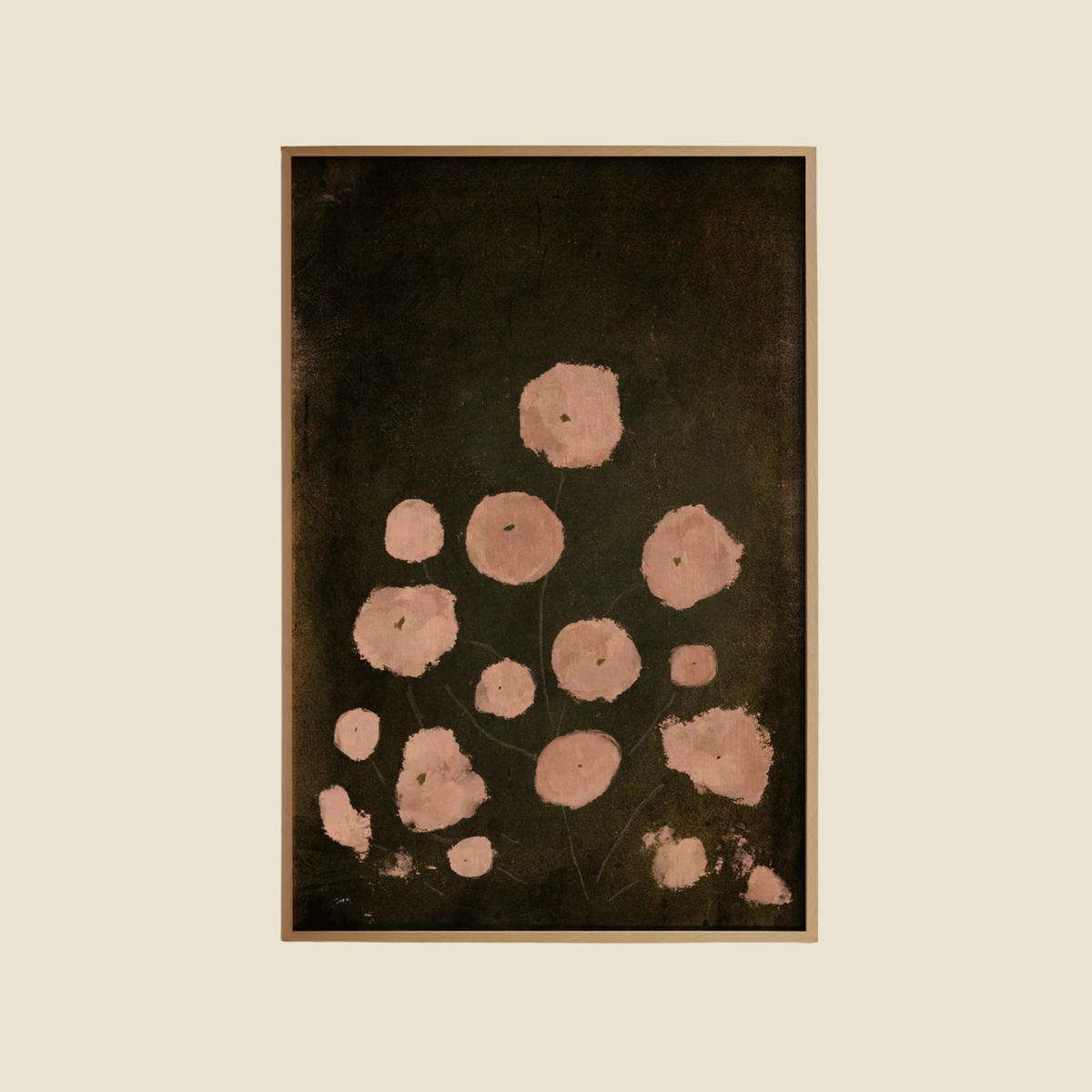 A framed abstract art print featuring textured pink circular shapes on a dark brown background, set against a solid cream backdrop.