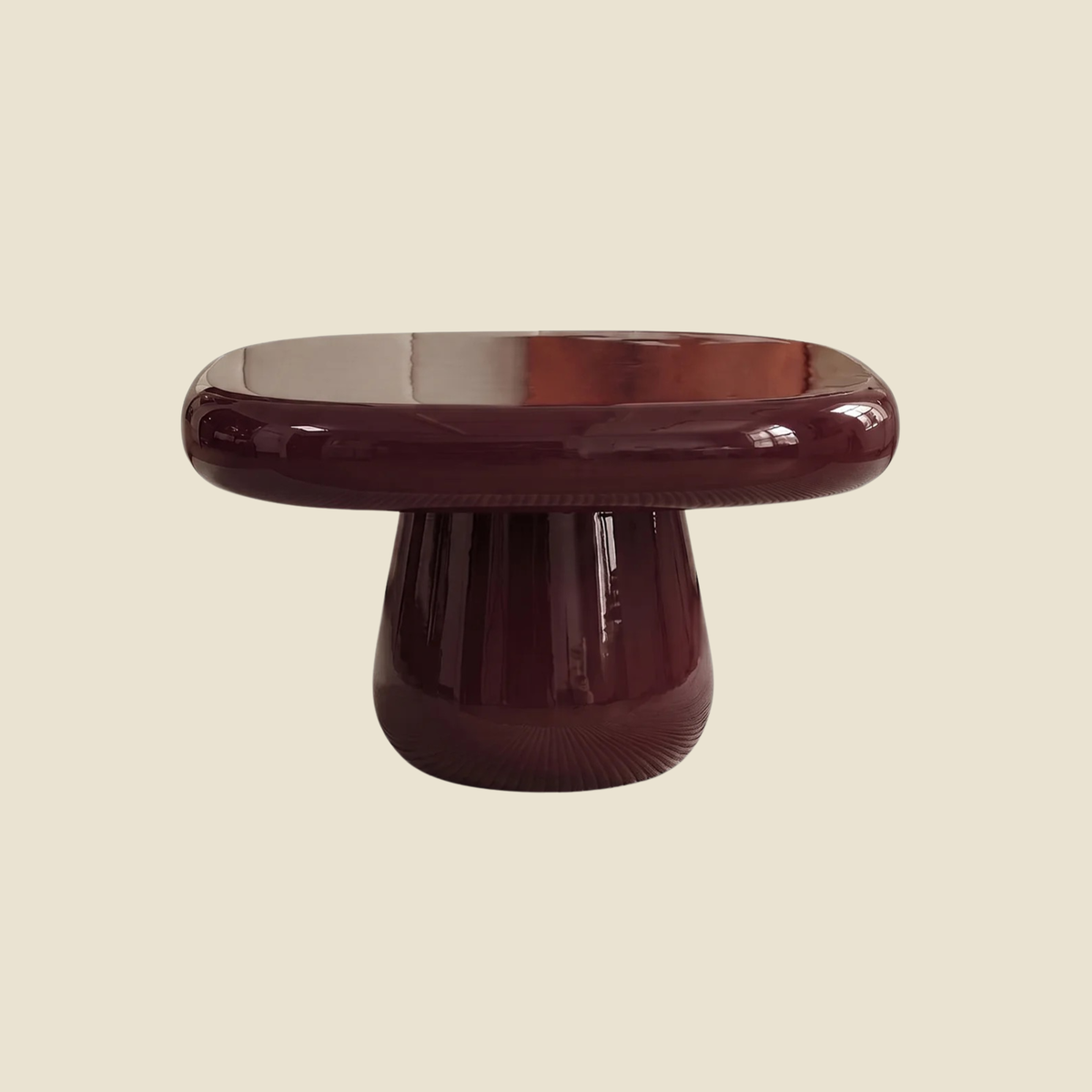 A glossy mushroom-shaped side table or stool in a deep burgundy glass, shown against a solid light beige background.