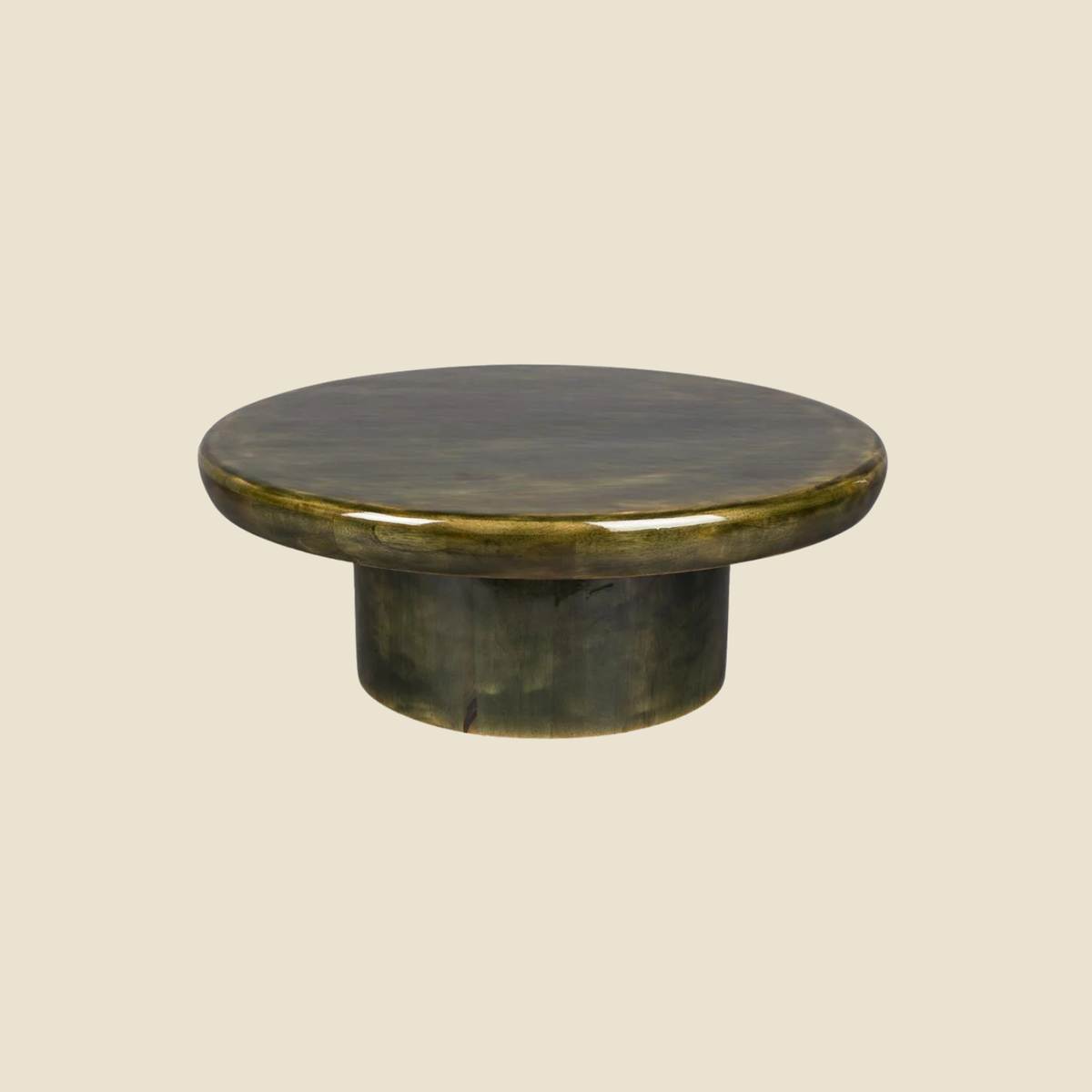 A round, low-profile coffee table with a distressed dark wood finish and a glossy brass-toned rim, shown against a solid light beige background.