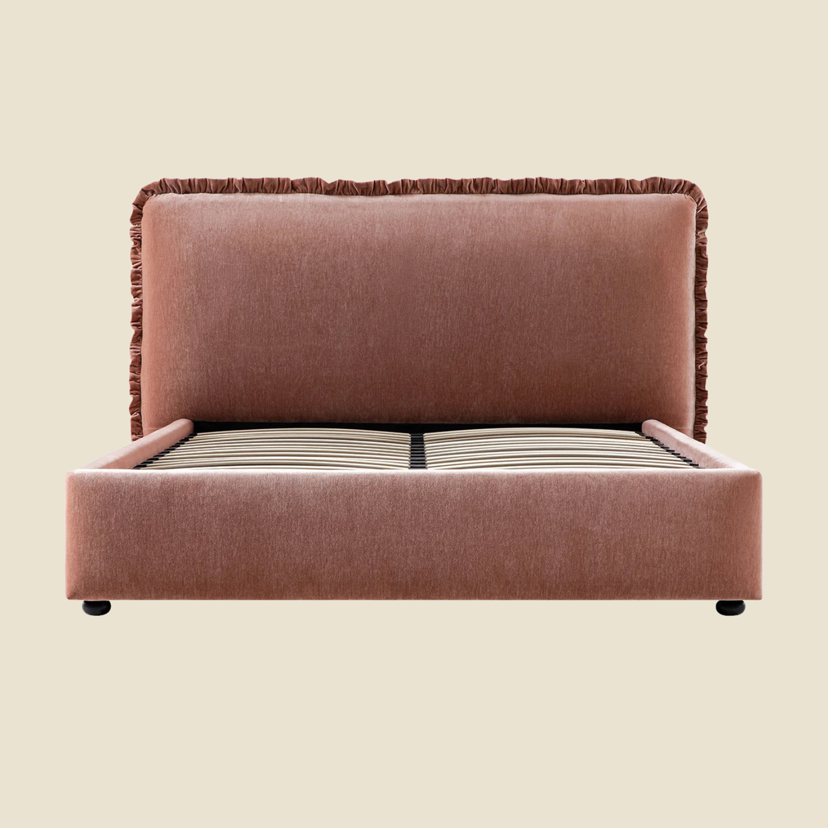 An upholstered bed frame with a tall, square headboard and footboard in a dusty rose fabric, shown against a solid light beige background.
