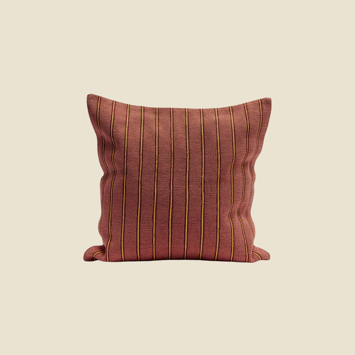 A square throw pillow in a textured rust-red fabric with vertical yellow stripes, centered on a solid beige background.