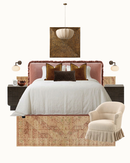 A styled bedroom furniture and decor set on a white background, featuring a bed with a dusty pink upholstered headboard, white bedding, brown accent pillows, a beige fringed armchair, a patterned area rug, wall sconces, a hanging pendant light, and a framed artwork.