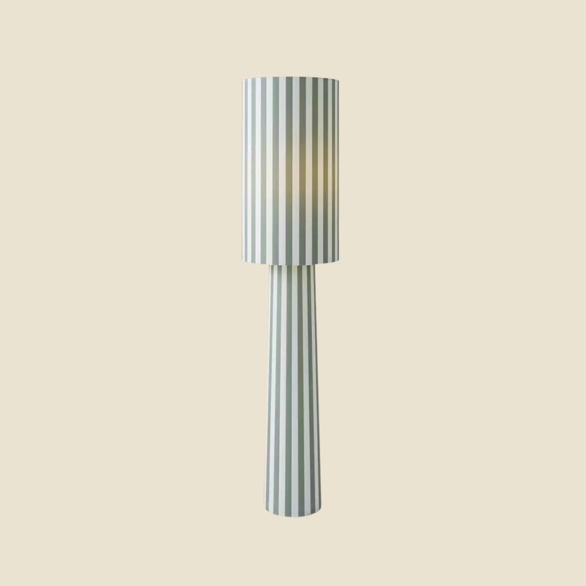 A modern floor lamp with a tapered cylindrical shade and matching base, featuring vertical stripes in sage green and off-white, set against a solid beige background.